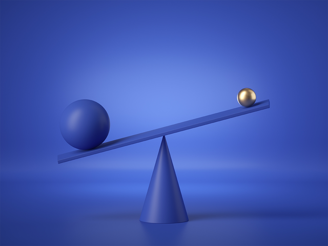Balancing blue and gold balls on a weighing scale