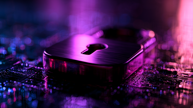 A padlock with a large keyhole lying flat on a computer board with purple lighting
