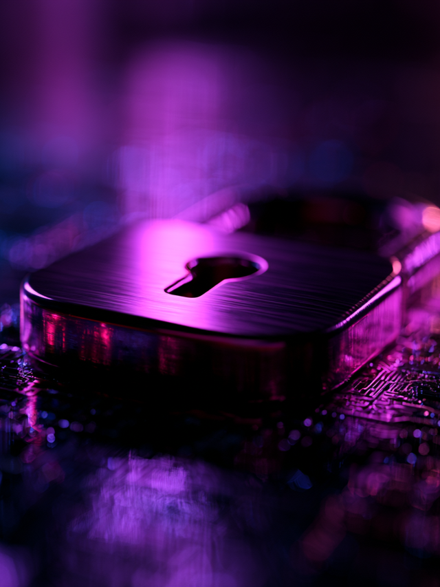A padlock with a large keyhole lying flat on a computer board with purple lighting