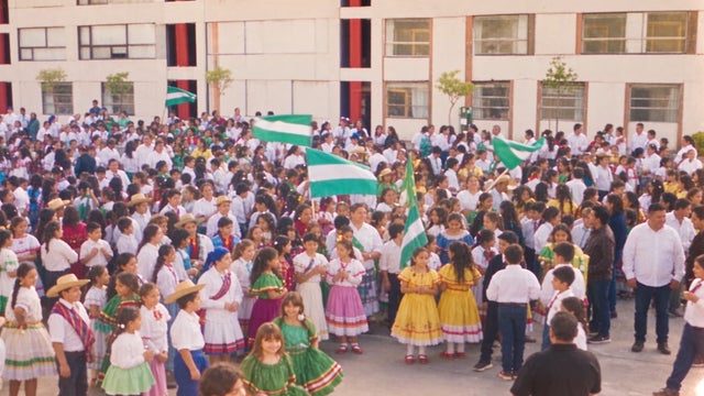 A group of students waving Bolivian flags