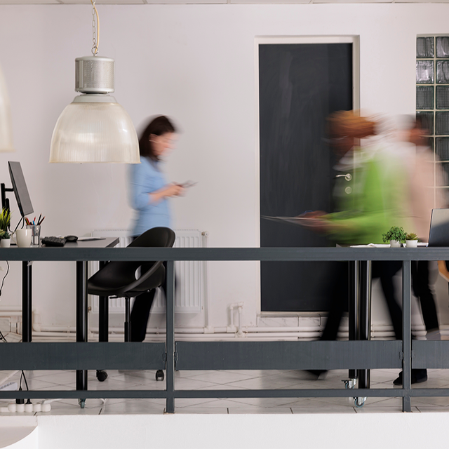 People walking through an office with motion blur