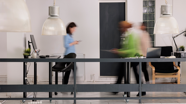 People walking through an office with motion blur