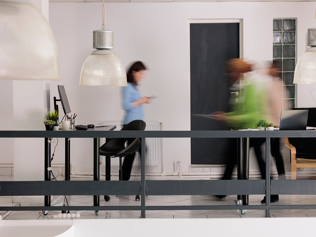People walking through an office with motion blur