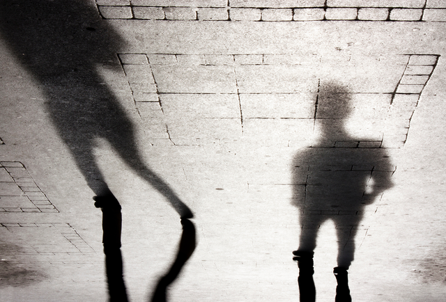 Blurry shadow silhouettes of two people 