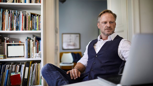 Businessman using laptop on desk in home office