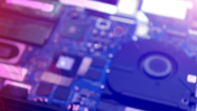 Blurred computer circuit board in purple and blue shades