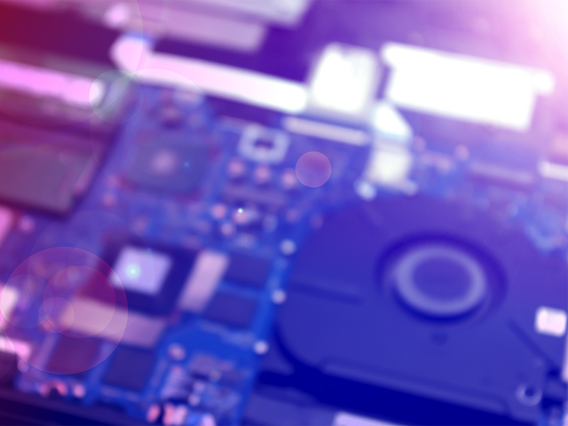 Blurred computer circuit board in purple and blue shades