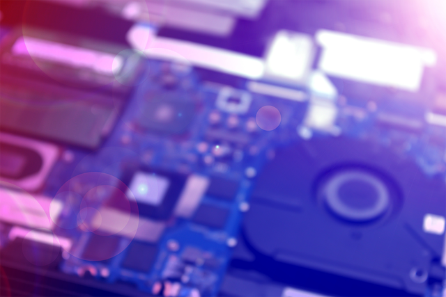 Blurred computer circuit board in purple and blue shades