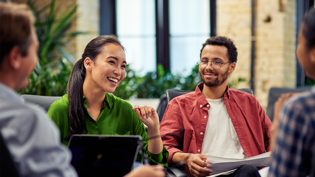 Four workers in a meeting on comfortable chairs