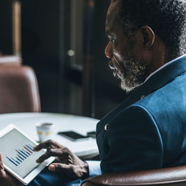Man looking at a chart on a tablet