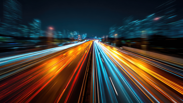 Streaking blurry car headlights on a busy highway at night